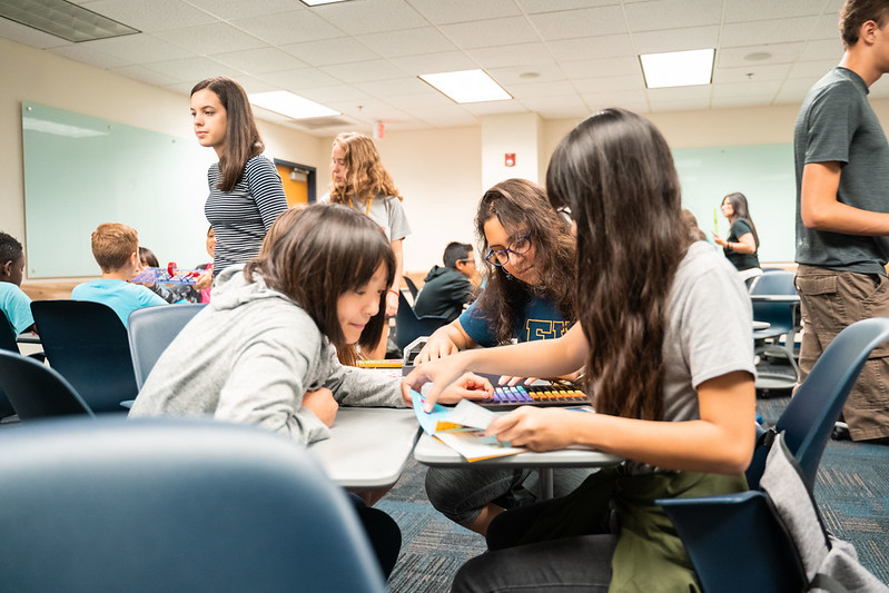 Student collaborating together on a project sitting