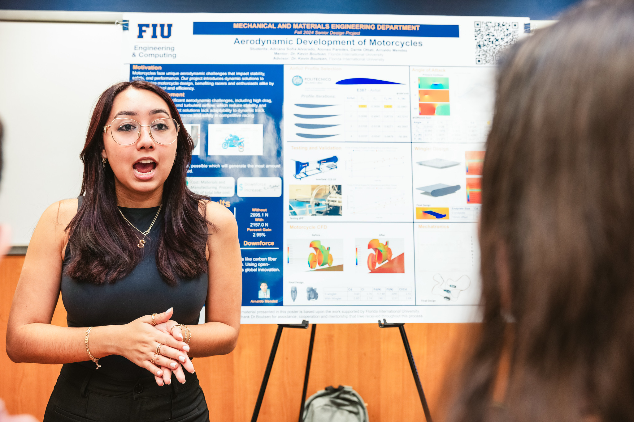 Student with open mouth explaining research