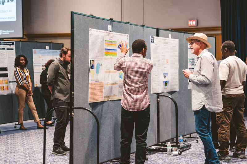 Student explaining research to faculty member