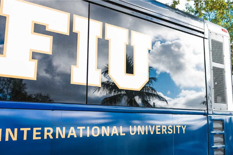 FIU Logo on a Bus parked outside a school