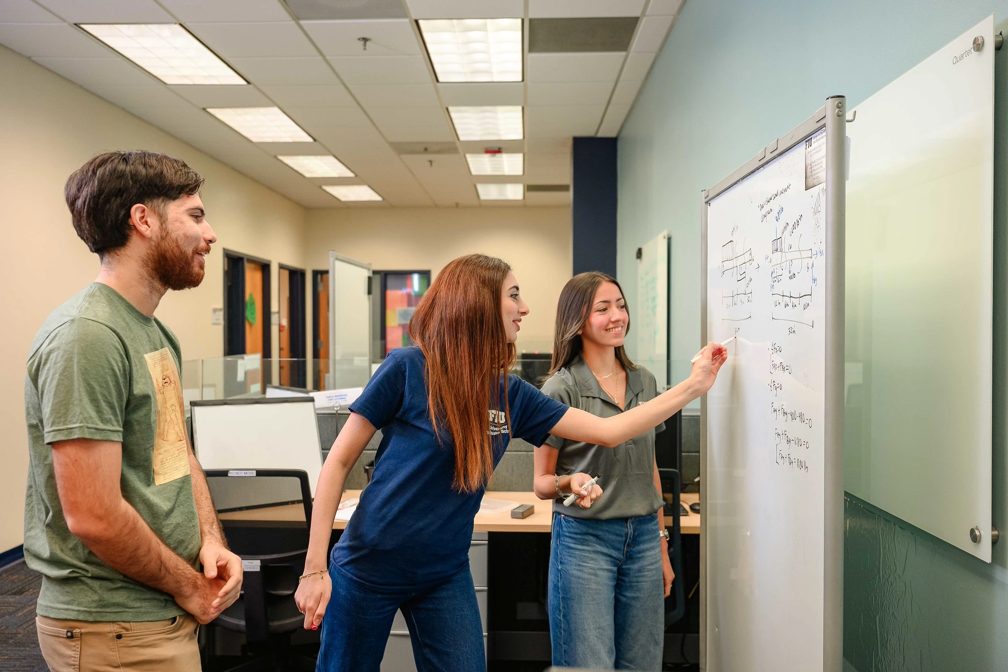 Two students peer teaching a fellow student 